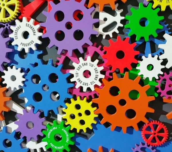 A colorful arrangement of gears symbolizing creativity, innovation, and machinery in vibrant colors.